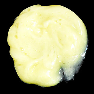 Creamy yellow cleanser texture — transforms from oil to milk with water, made with honey and gentle botanicals