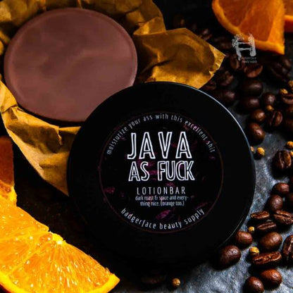 A coffee lotion bar is shown surrounded by coffee beans, oranges, and spices.