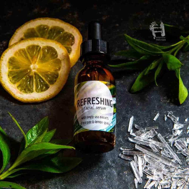 An amber glass bottle of face serum for oily skin is shown surrounded by lemon slices and fresh herbs.