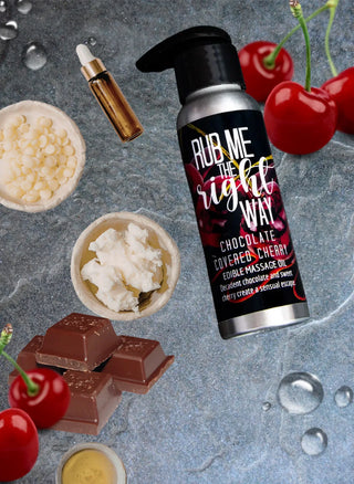 Chocolate cherry flavored edible massage oil is shown surrounded by the natural ingredients it's made from in this photo by Badgerface Beauty Supply.