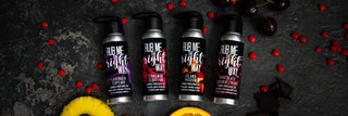Four different flavors of Rub Me the Right Way edible massage oils are shown on a dark background.
