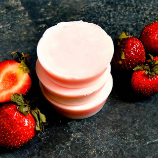 This solid moisturizing bar is scented with strawberry, pink grapefruit, and ginger.